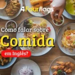 Dica de inglês da escola de idiomas FourFlags em São Caetano do Sul ensinando 'Como falar sobre comida em inglês' com a imagem de uma mesa de madeira cheia de pratos variados vistos de cima.