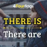 Dica de inglês da escola de idiomas FourFlags em São Caetano do Sul explicando quando usar there is e there are com a imagem de uma criança apontando para algo à frente.