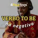 Verbo to be na negativa em inglês: imagem ilustrativa com homem sorridente usando fones de ouvido e escrevendo no caderno em ambiente de estudo, oferecido pela FourFlags Language Center